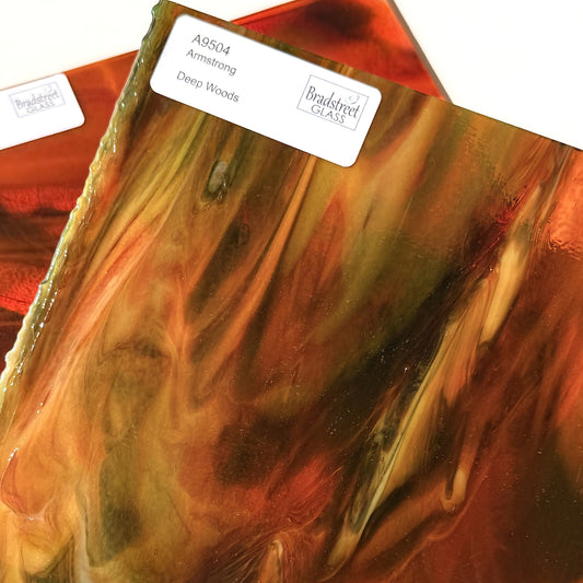 Armstrong 9504 Stained Glass Sheet Deep Woods: Dark Brown and Bright Golden Ambers with Greens. Streaky swirled art glass at Bradstreet Glass.