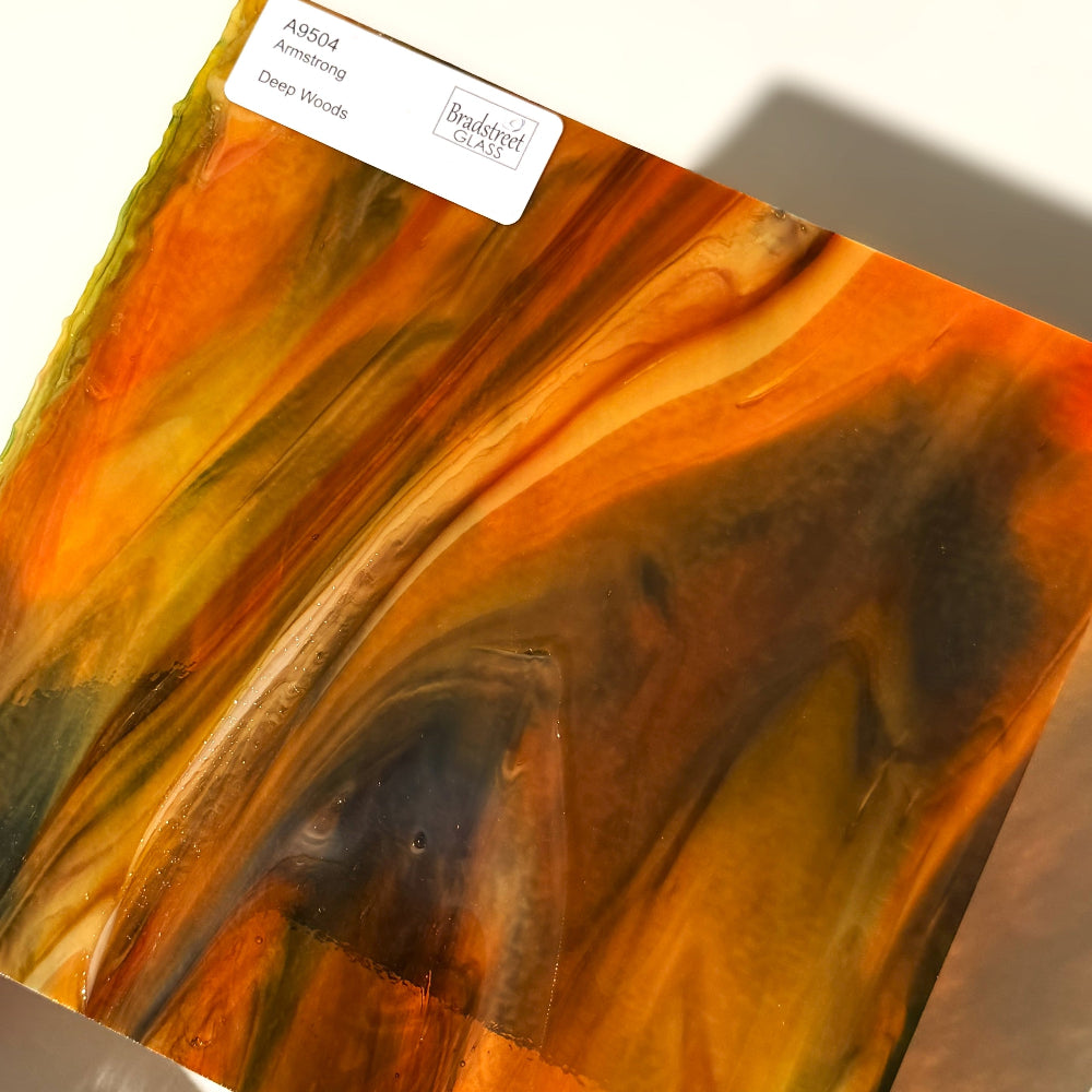 Armstrong 9504 Stained Glass Sheet Deep Woods: Dark Brown and Bright Golden Ambers with Greens. Streaky swirled art glass at Bradstreet Glass.